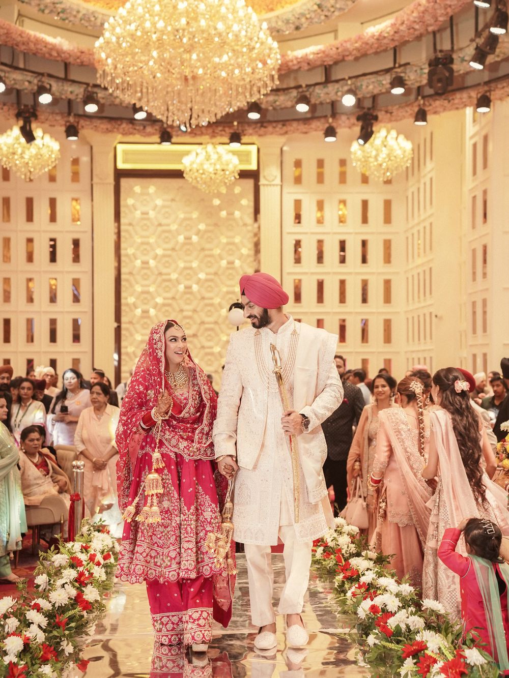An Indian wedding ceremony, the couple beneath a decorated canopy with guests seated around