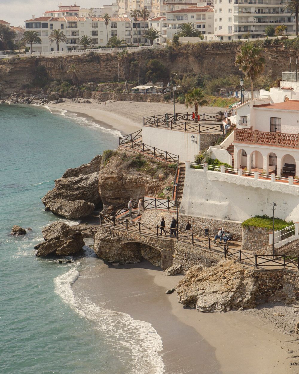 A cove below whitewashed terraces on the Portuguese coast
